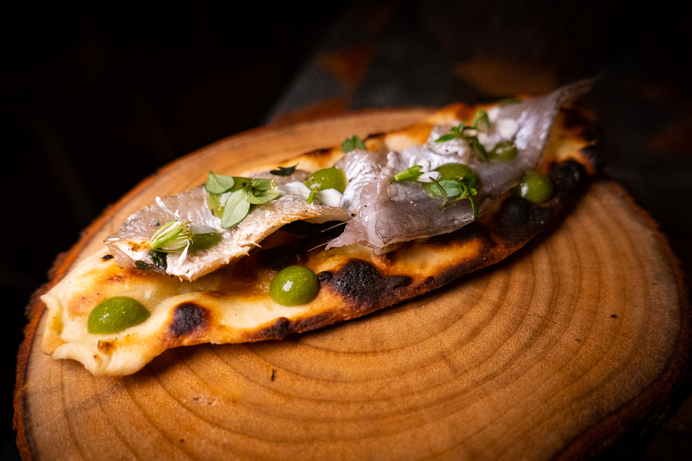 Fermented naan bread with anchovies at Botanik, a seasonal, mostly plant-based sustainable restaurant in Shanghai. Photo by Rachel Gouk. 