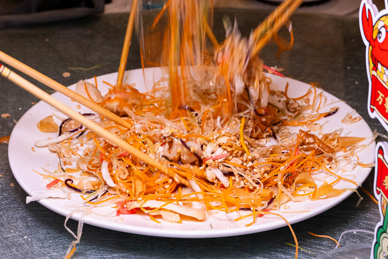 Yee Sang or Lou Hei or Yu Sheng is a popular festive dish in Malaysia and Singapore, eaten during Chinese New Year for prosperity and luck.