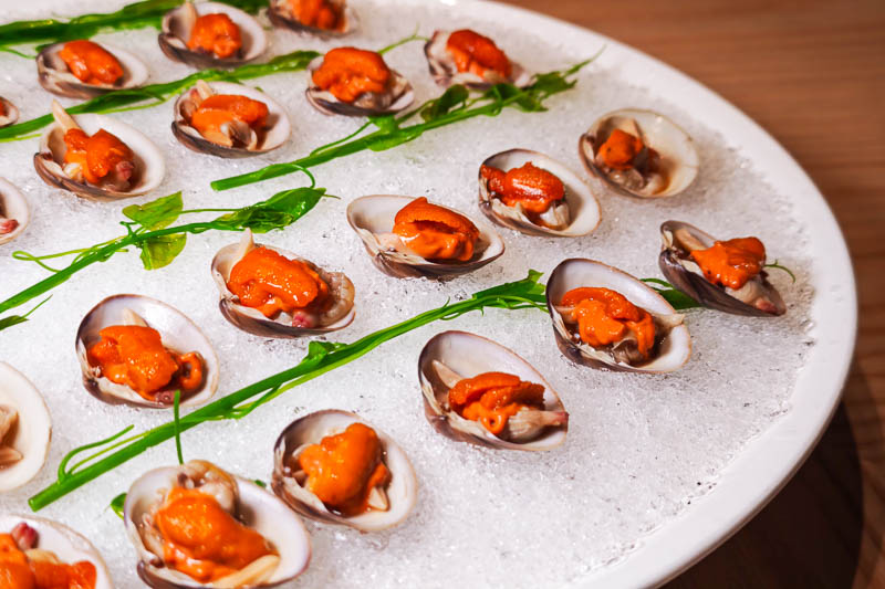 Clams topped with sea urchin served over ice