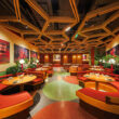 Interiors at Melt in July restaurant, a wide angle showing a large space with banquette seating.